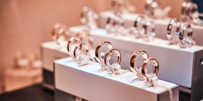 Set of different gold rings on the showcase of a luxury jewelry store, Close-up photo