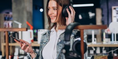 Woman choosing earphones at store